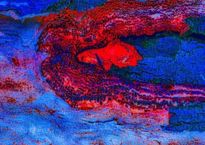 Abstract image of vibrant blue and red textures resembling flowing lava or water against a rugged surface